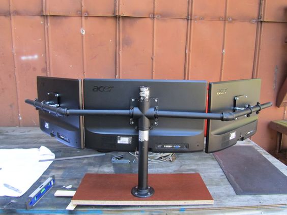 This image shows a triple monitor stand.